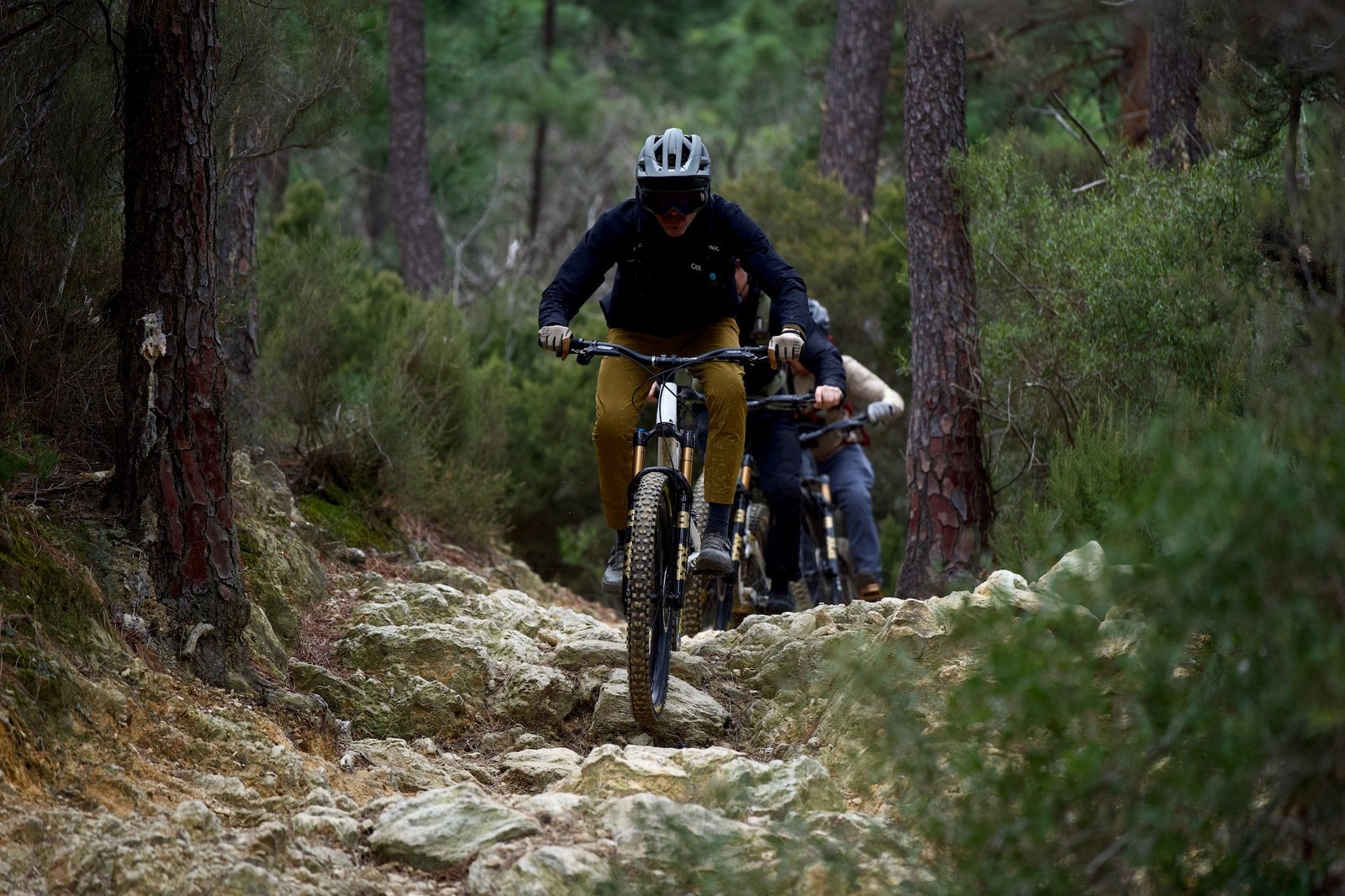 riding down a chunky mountain bike trail in Finale Ligure with the Race Face Atlas handlebar.