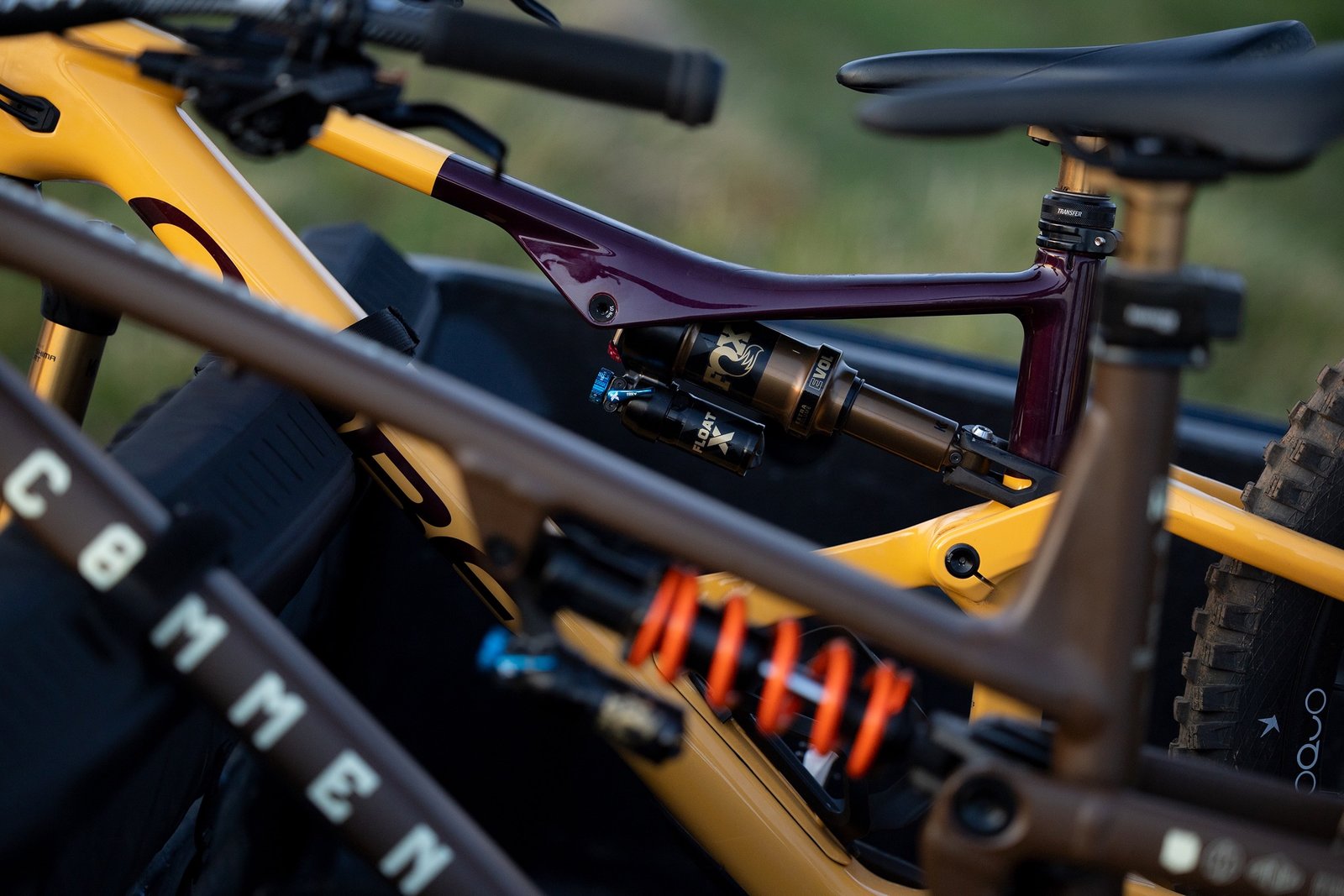 two bikes with the updated DHX and Float X shocks on a tailgate pad in the bed of a truck.