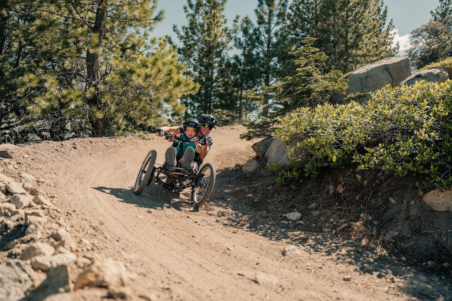 A person riding an adaptive bike on the High Fives Trail at Sky Tavern Bike Park