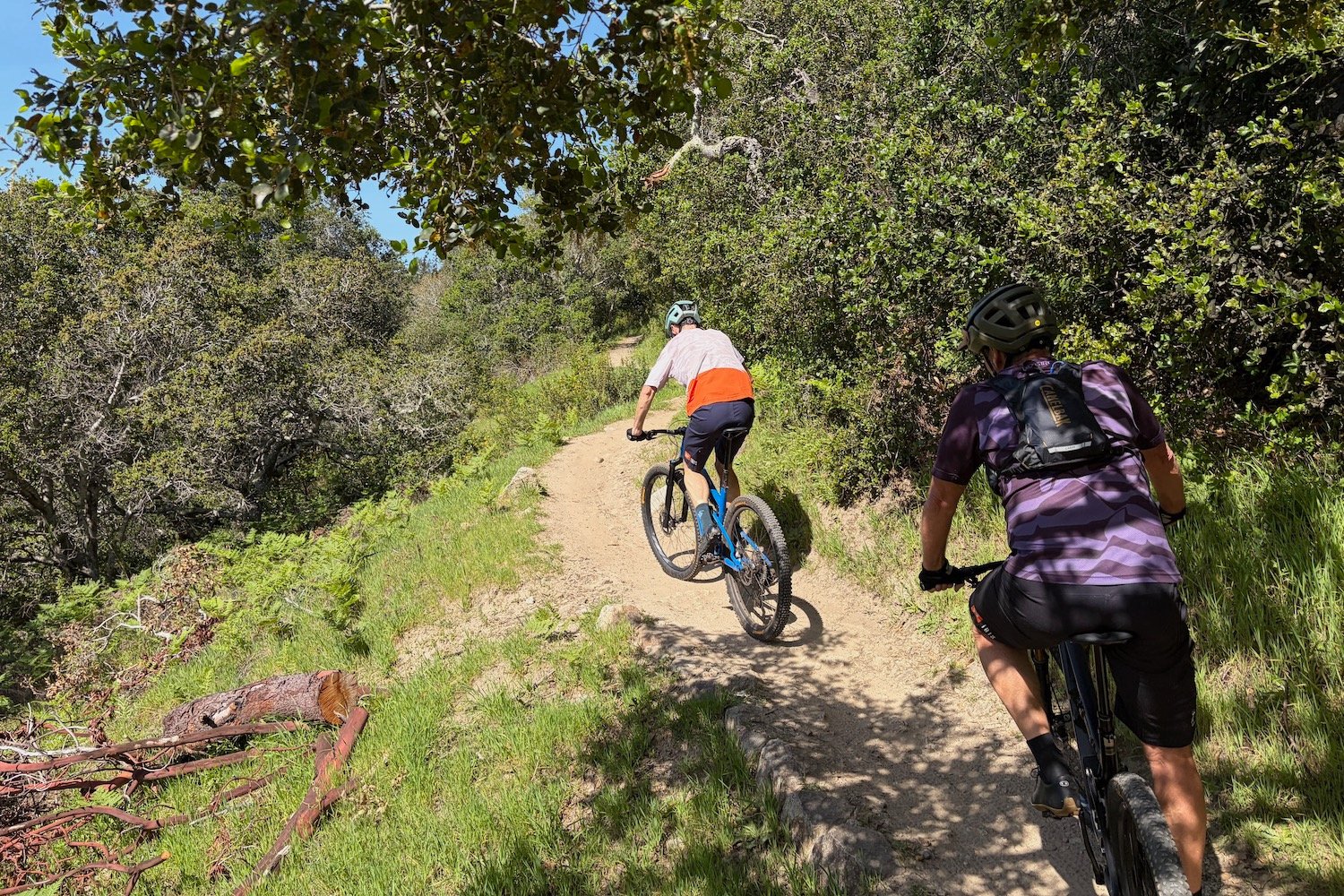 colin hughes and scot nicol climbing a singletrack trail in Santa Cruz, CA.