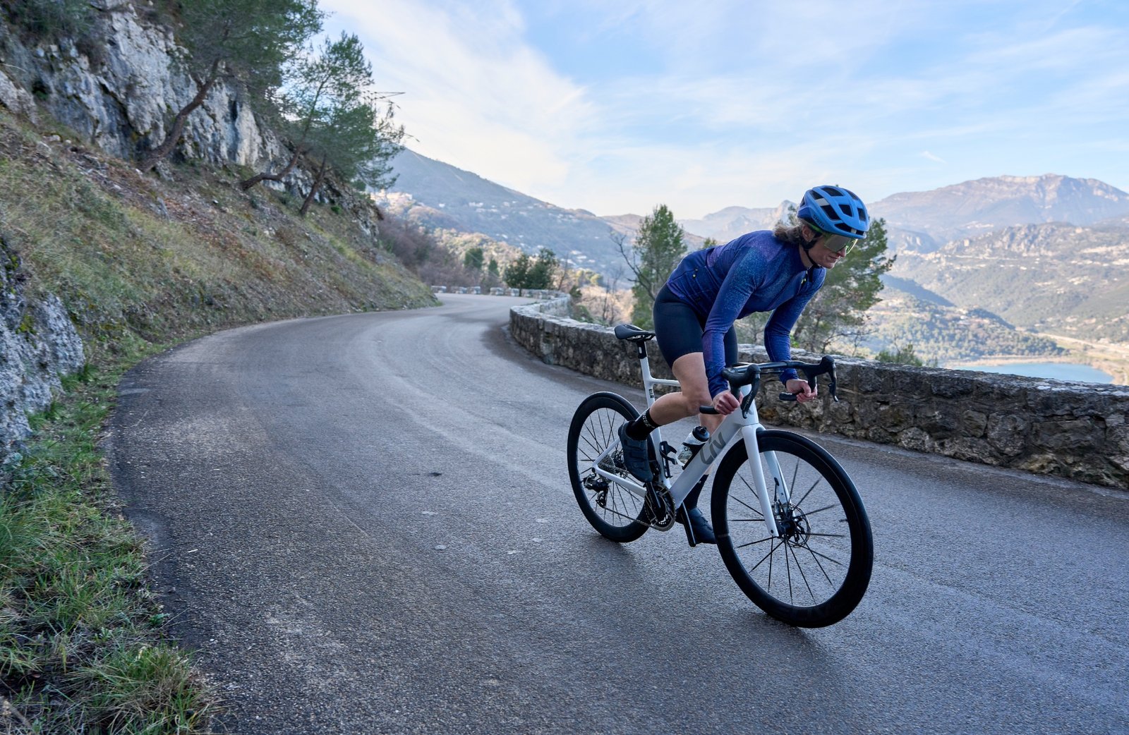 Author rides the Liv EnviLiv in on a road with mountains in the background