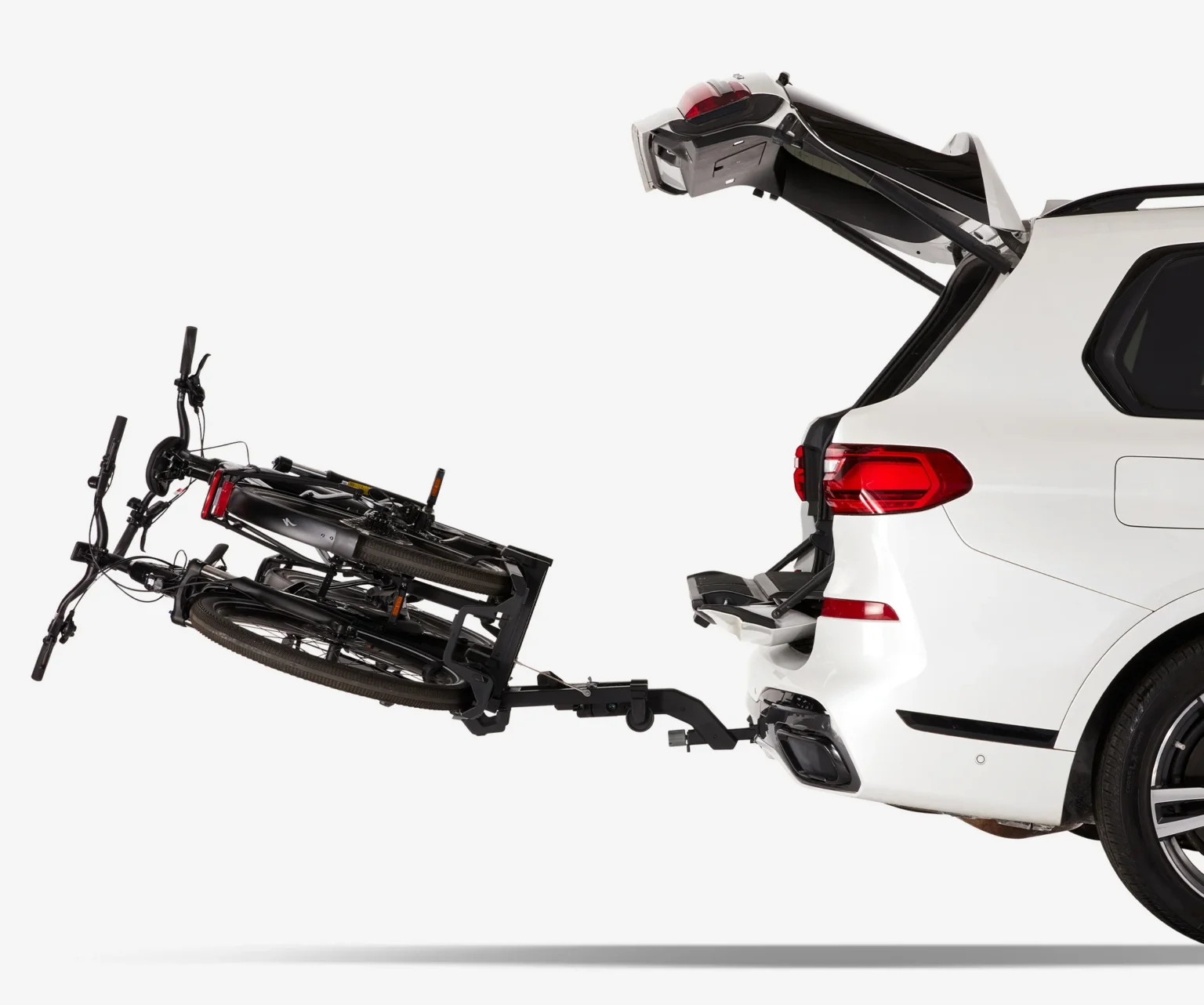 saris cycle-on hitch bike rack shown folded down with bikes on it.