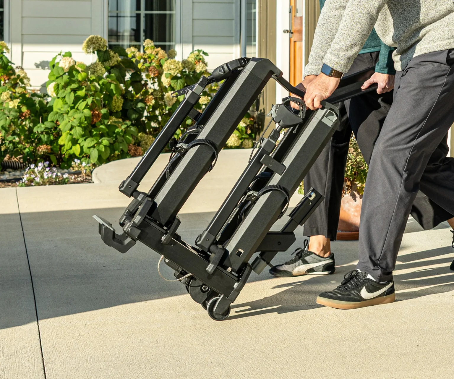saris cycle-on hitch bike rack folded up and being rolled.