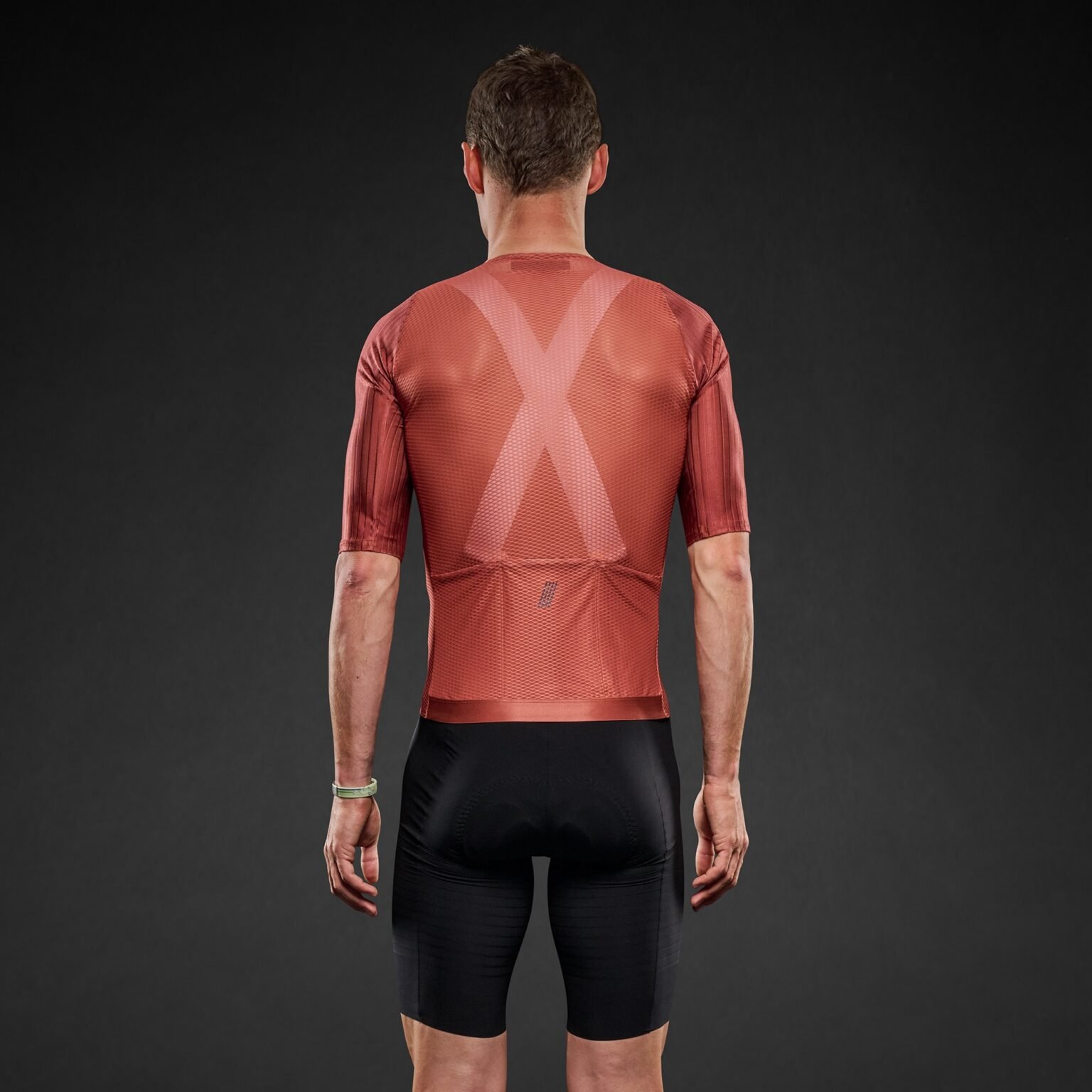 studio image of a man wearing the Pi Black mesh jersey, viewed from behind.