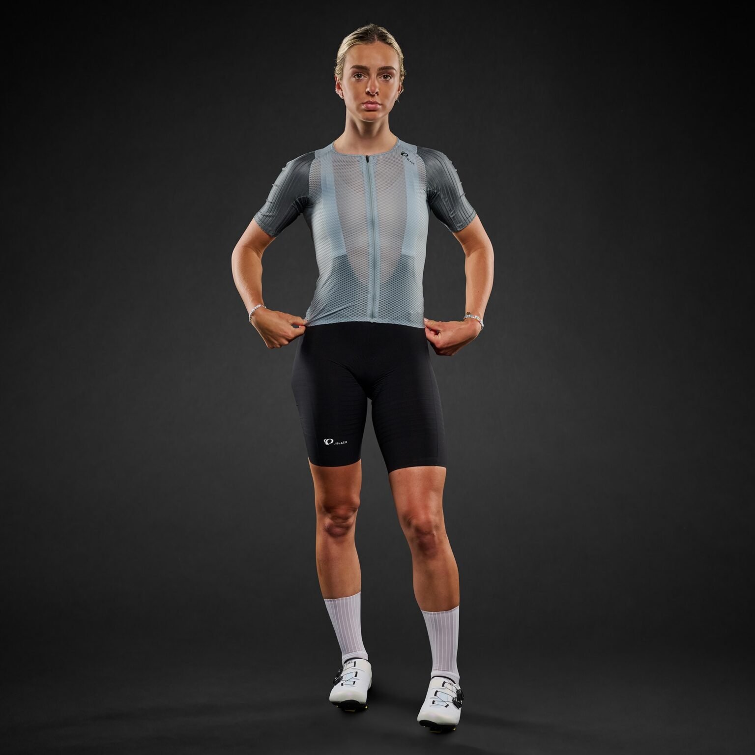 studio image of a woman wearing the Pi Black mesh jersey, viewed from front.