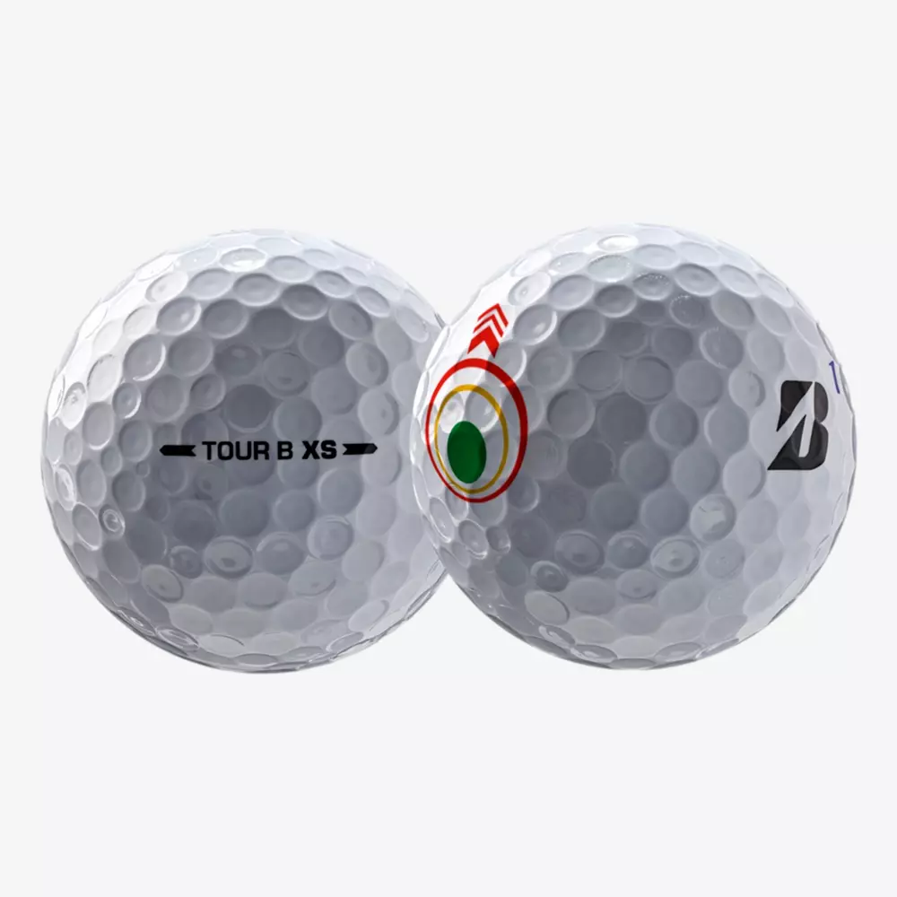 Two white dimpled golf balls are shown. One displays TOUR B XS in black text, while the other features a stylized red, yellow, and green circular logo with a black B—perfect choices for those seeking the best golf balls 2026 has to offer.