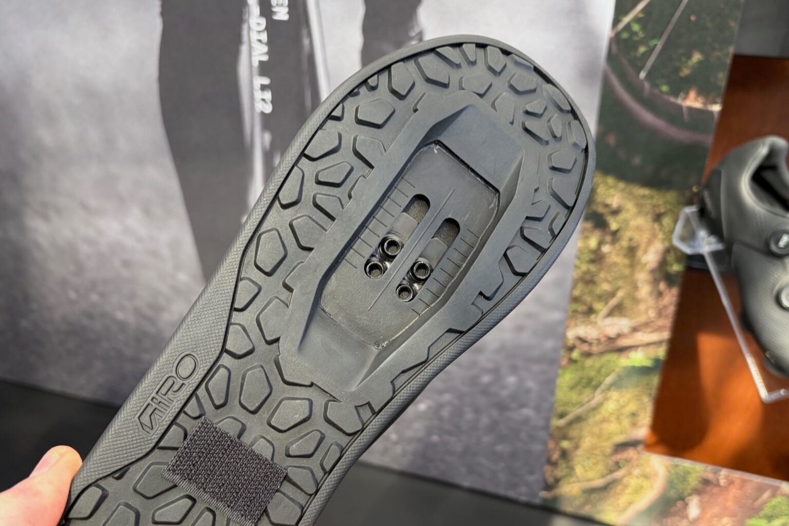 holding the Chamber Trail shoe and looking at the outsole