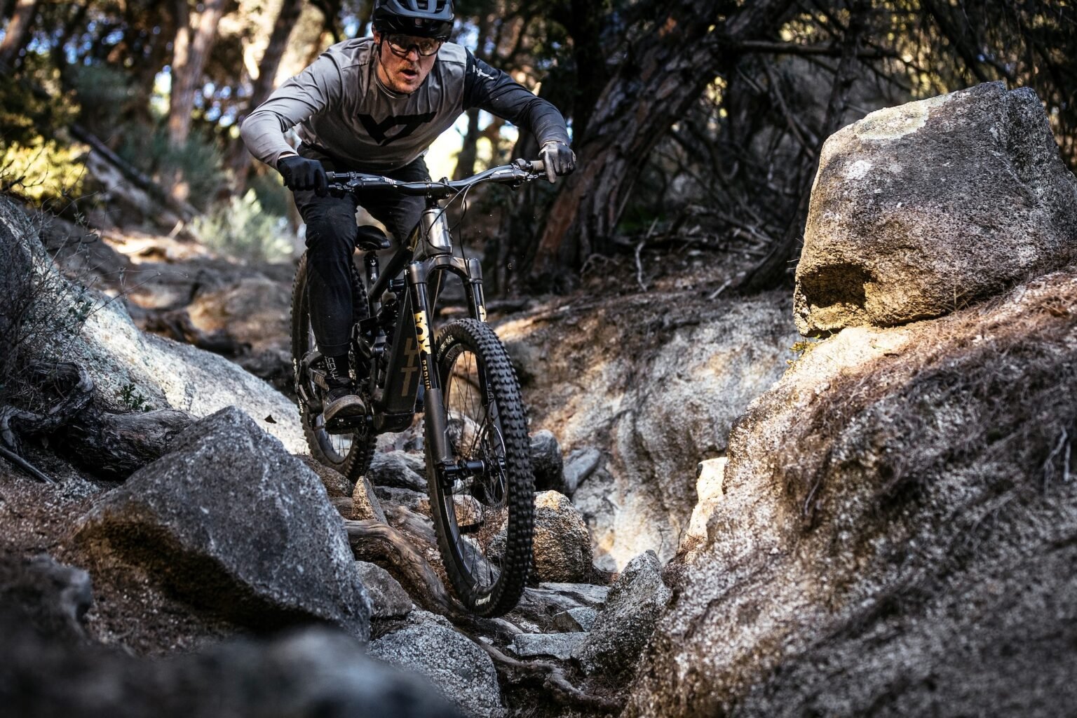 a guy riding the YT Decoy X down some chunky rocks