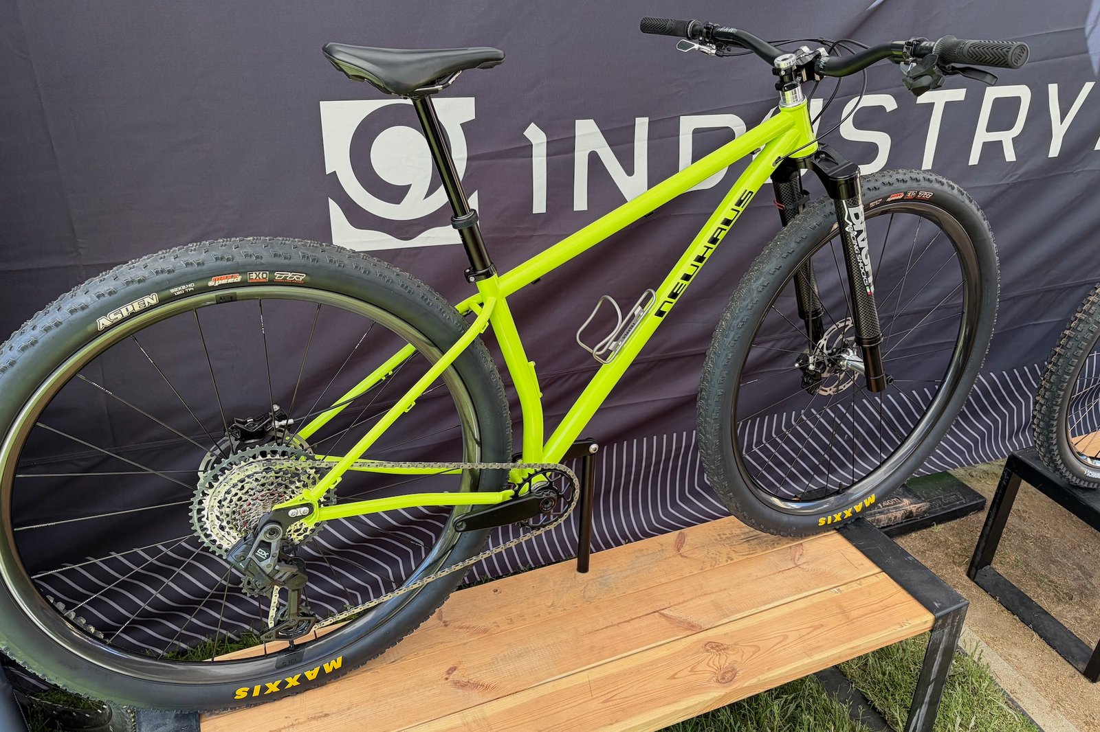a bright green/yellow Neuhaus NOVA32 hardtail in the Industry Nine booth at Sea Otter