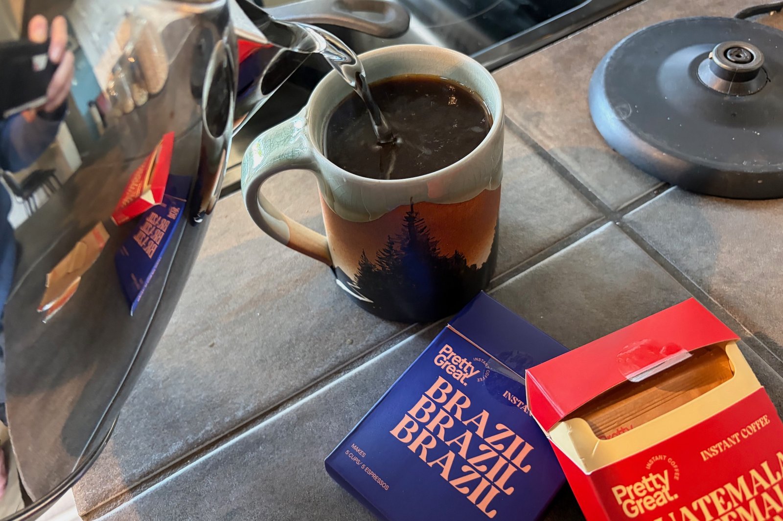 adding water to the instant coffee granules while making some Pretty Great Instant coffee.