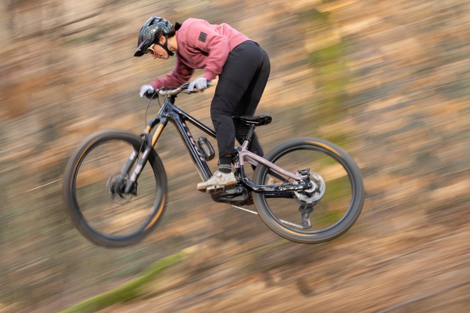 a Pivot rider jumping on the new PIVT Shuttle AMP'd eMTB