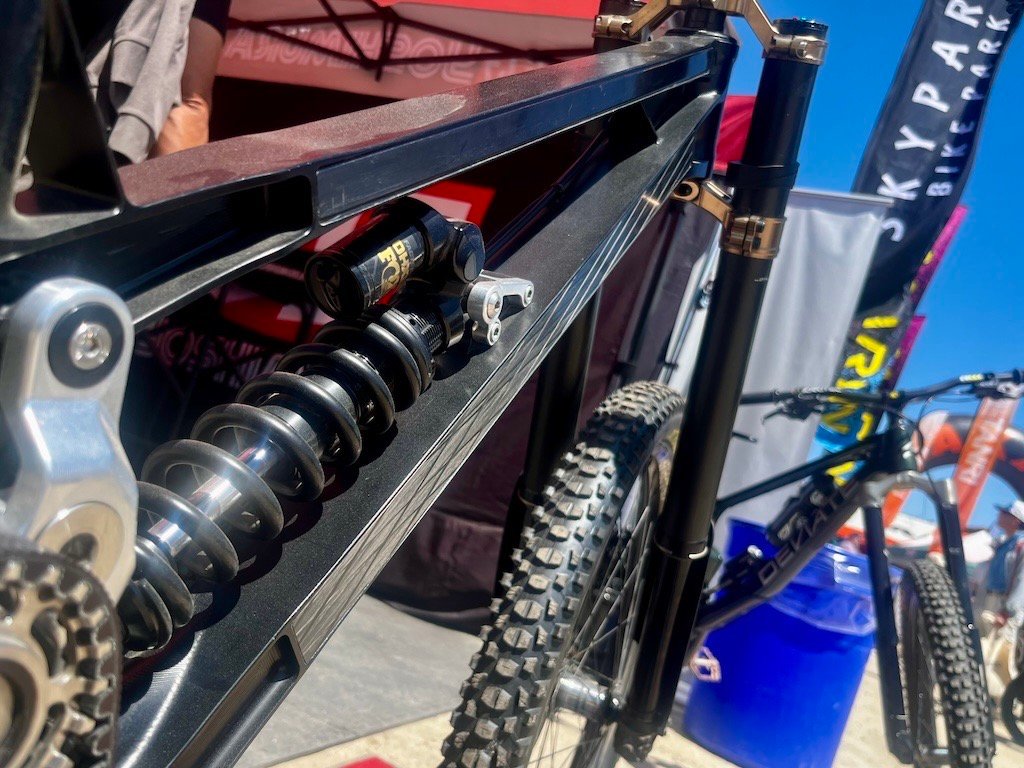 these carbon shims on the side of the Gamux prototype DH bike help tune stiffness