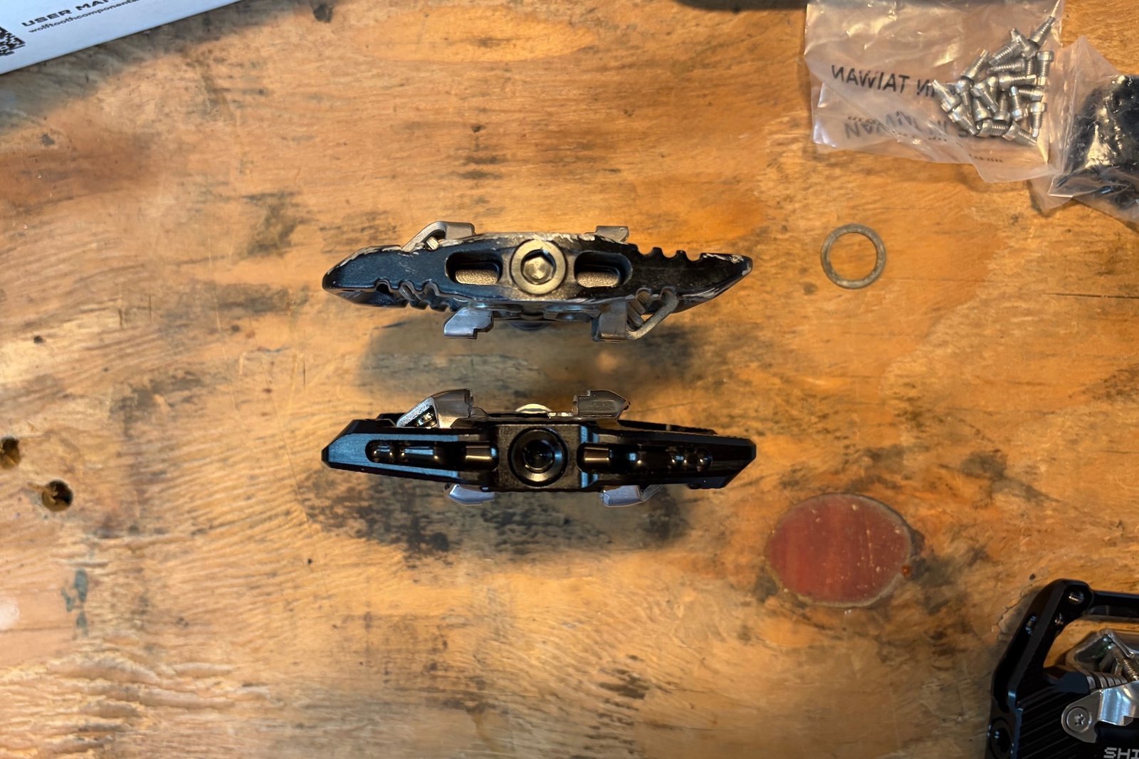 comparing the thickness and size of the Wolf Tooth Shift pedals to the OneUp Clip.