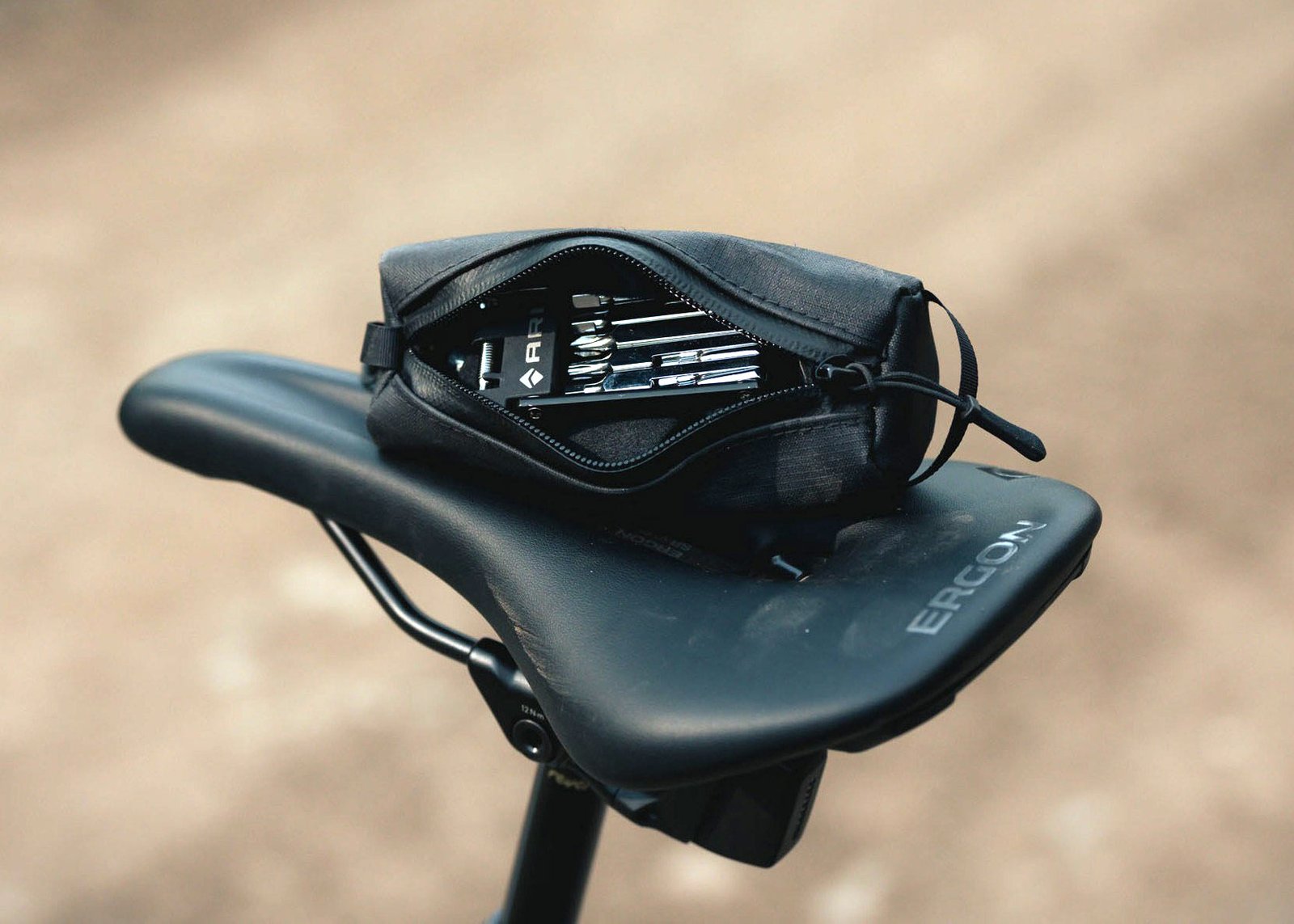 ari cache tool pouch shown open with bike tools inside.