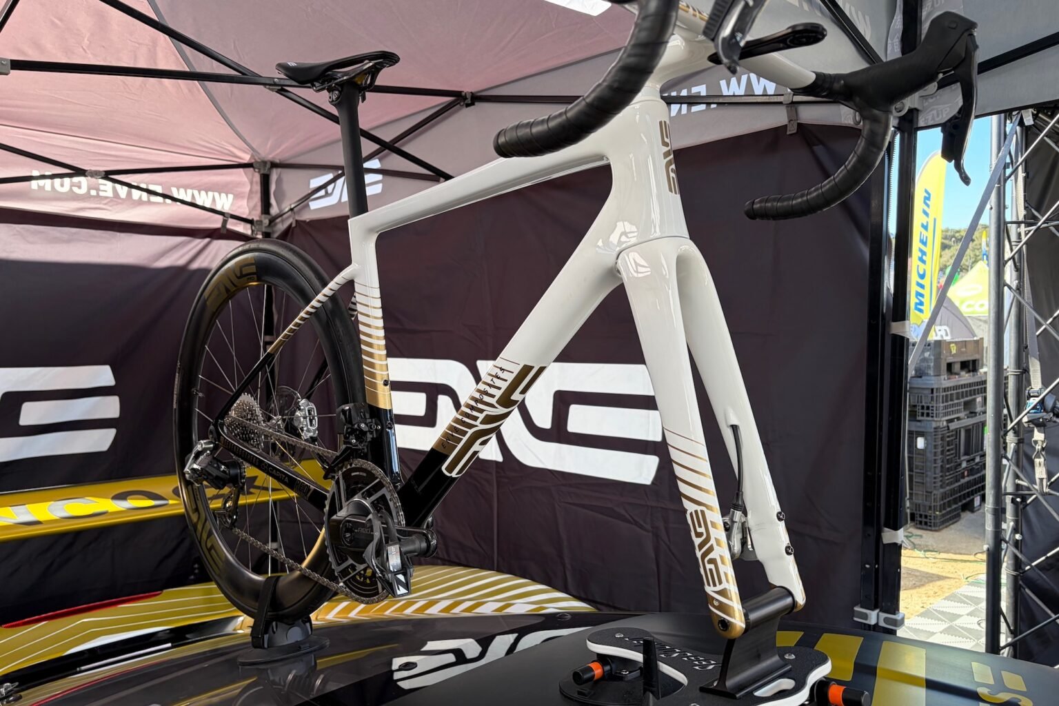 A custom painted Enve road bike on the roof of a ferrari