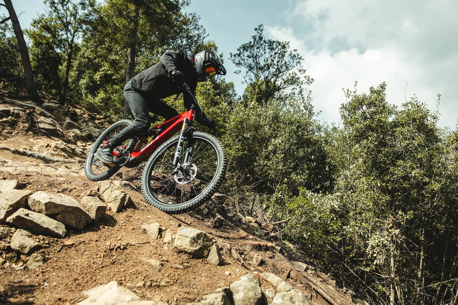 a person riding the new BH iLynx+ DL eMTB down a rock trail.