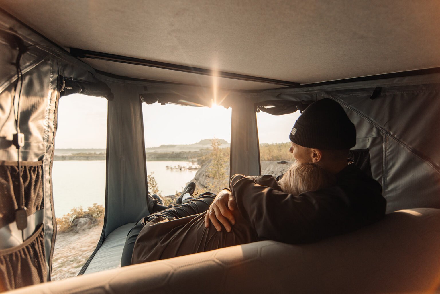 couple inside the thule widesky rooftop tent.