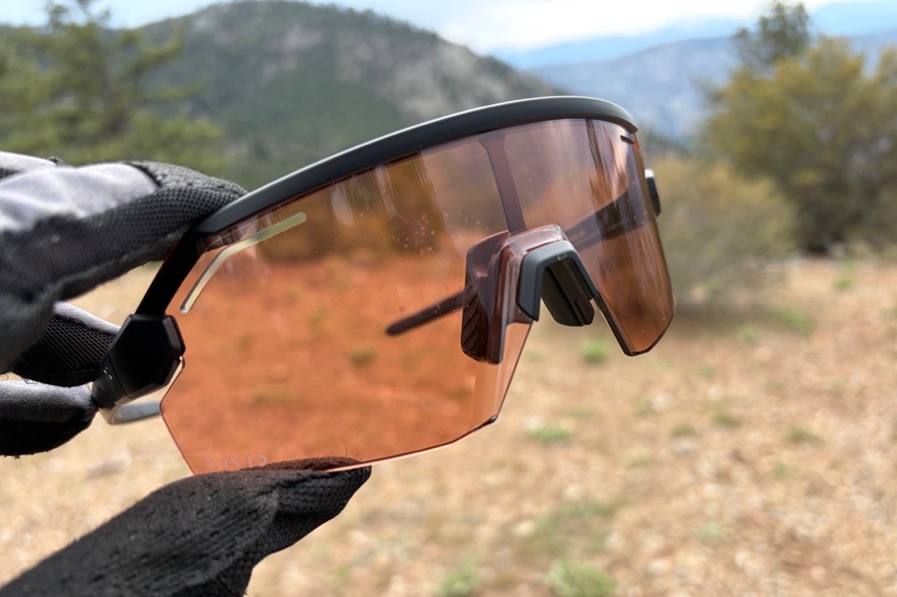 looking at the Fox Vue Pro lens, holding them in front of mountains